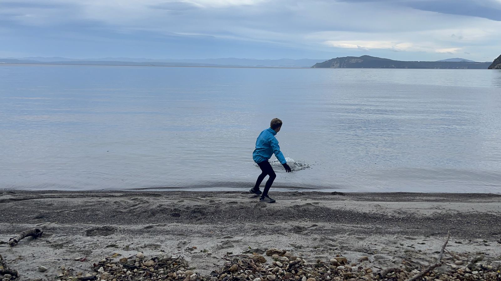 Skipping stones on the lake shore