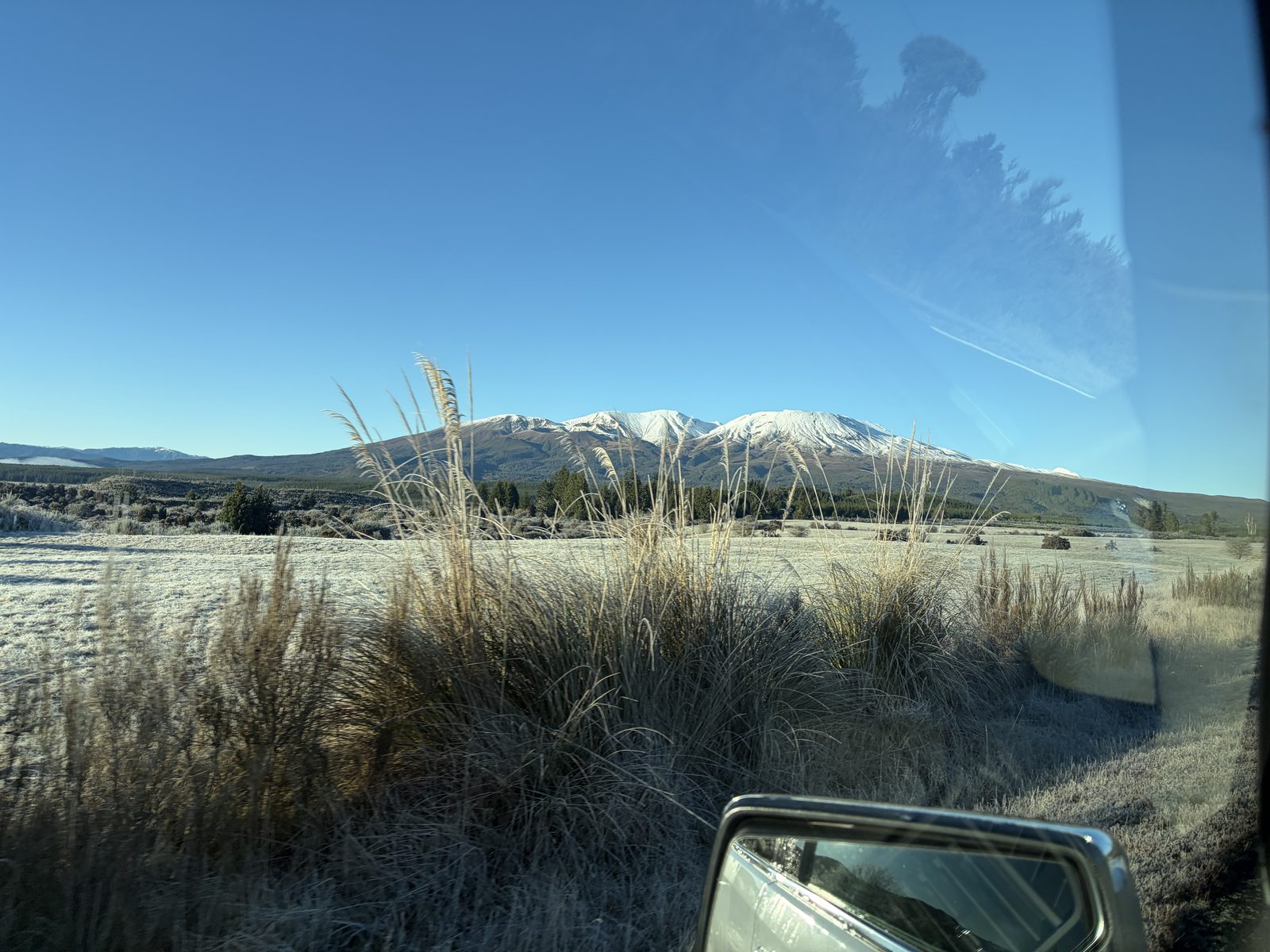 Frosty field, mirror view of mountain